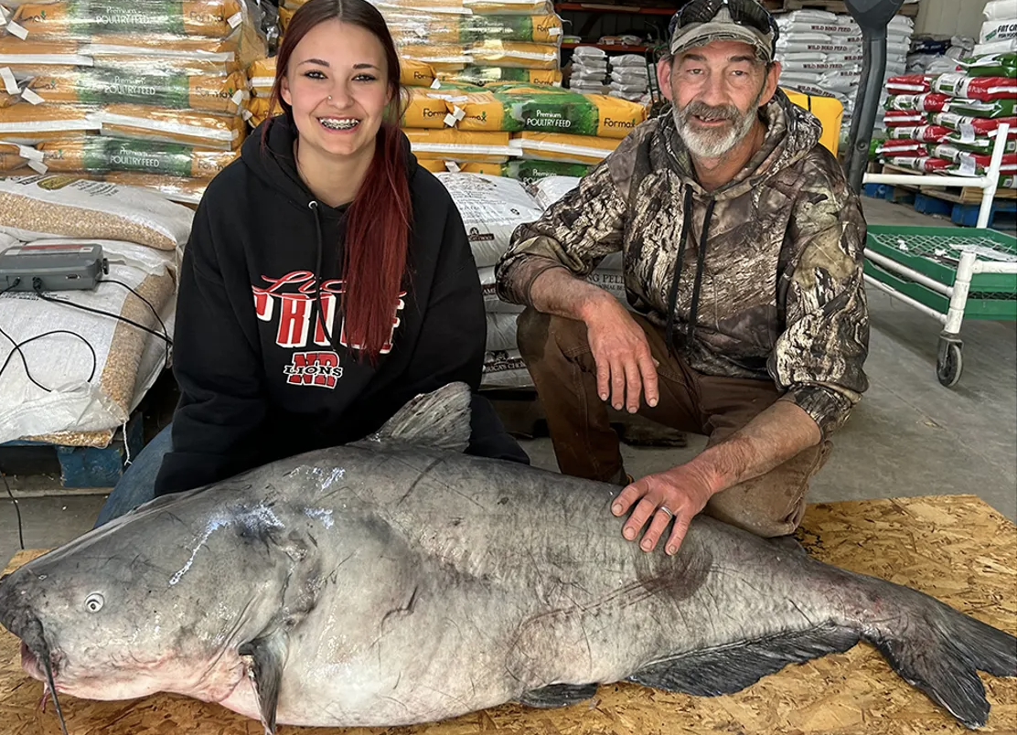 Jaylynn Parker and her dad, Chuck Parker. When the family was finally able to weigh the catch, the fish tipped the scales at more than 100 pounds. (photo by Kristen Parker)